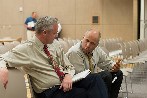 Faculty gather in the Hinckley Building at a Faculty Conference to share and learn from each other at the beginning of the 2013 Fall semester.