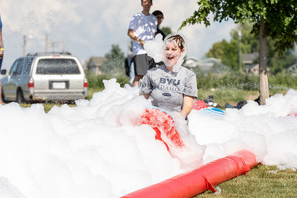Students gather by the upper fields on the BYU-Idaho Campus to play recreation games, slip 'n' slide, mud volleyball, and try the ropes course.