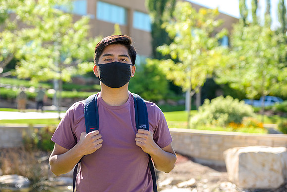 Student volunteers show the way to stay safe during this COVID 19 pandemic by social distancing, following pathway arrows and proper wearing of masks .