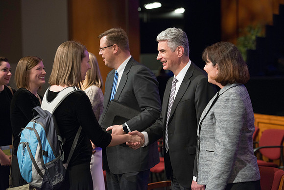 Bishop Gérald Caussé and his wife greet students after devotional.