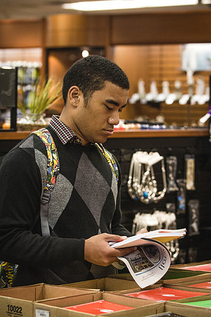 A man picks up notebooks on the first day of classes at the University Bookstore