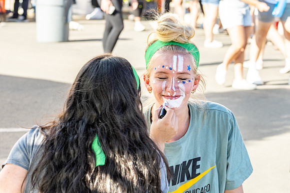 Students gather at the stadium to watch the football championship.