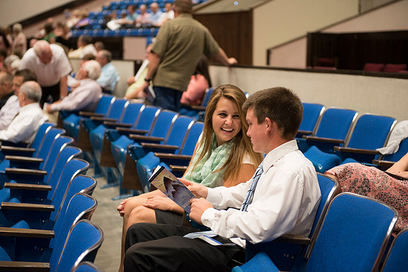 Audience members gather in auditorium for the preformance.