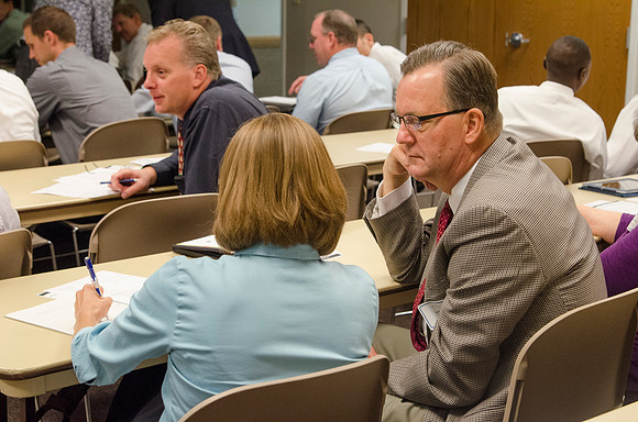 Faculty members discussing classroom topics during faculty meeting Fall 2013