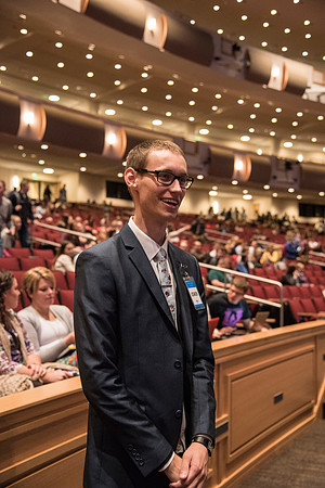 An usher greets students at the beginning of Devotional.