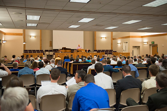 Faculty gather in the Hinckley Building at a Faculty Conference to share and learn from each other at the beginning of the 2013 Fall semester.