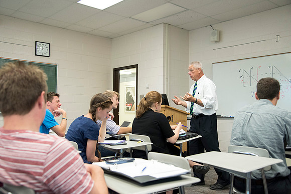 Brother Kerry Webb discusses with his class, the importance of understanding the past and future of the US economy.