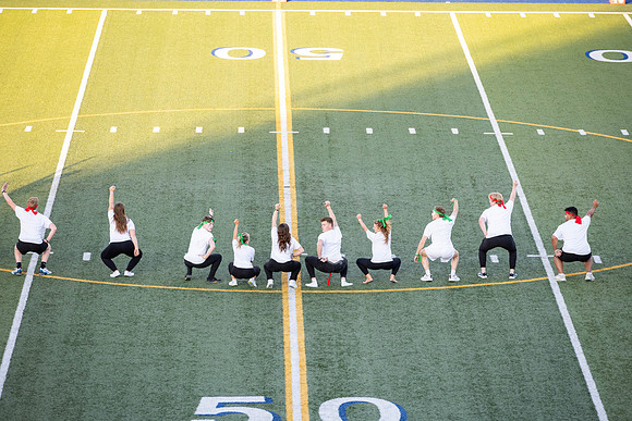 Students gather at the stadium to watch the football championship.