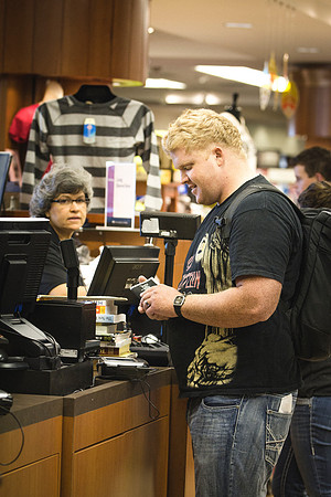A student purchases books from the University Bookstore at the beginning of the semester.