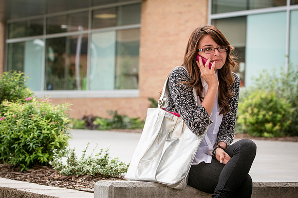 A woman talks on her phone on the first day of school