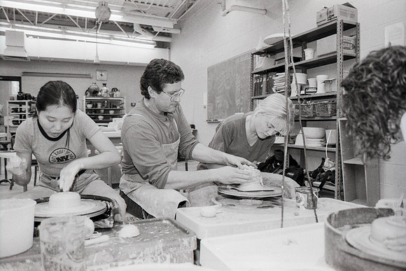 Rich Briggs helps a student as creates her piece of pottery.