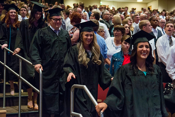 Graduates walking into the BYU-Idaho Center for the Processional march.