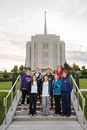 Team members pose by the Rexburg temple before they begin the temple to temple run