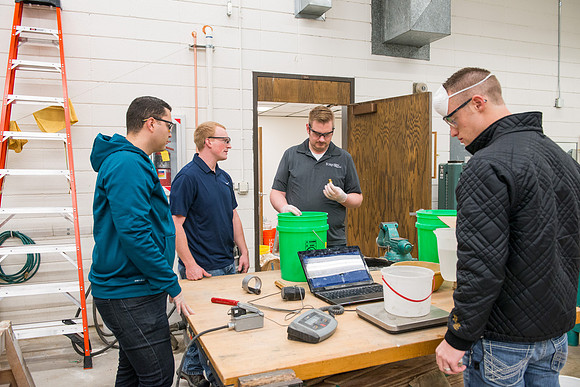 Civil engineering students work with different mixtures of cement to make a light, yet durable, cement that will be the building material for a canoe.