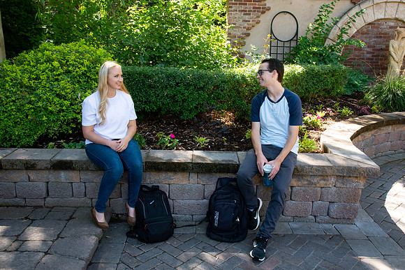 Examples of students staying safe and healthy during the COVID-19 pandemic by social distancing, following pathway arrows, and wearing face masks.