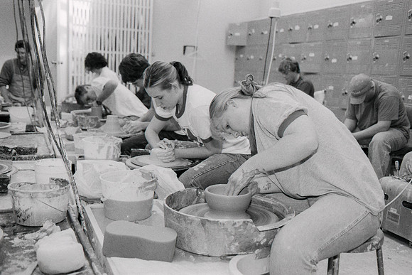Students work hard on the potter wheels to create their piece.