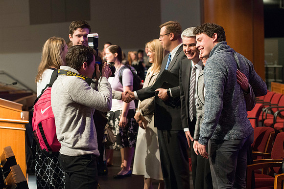Bishop Gérald Caussé and his wife greet students after devotional.