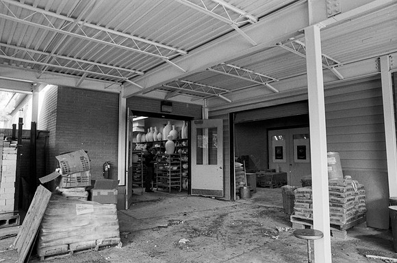 Matthew Geddes stands in the pottery room by the new constructed roof.