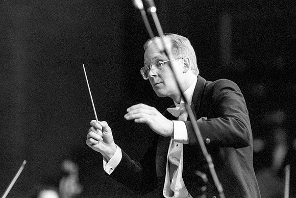 Conductor leading the orchestra