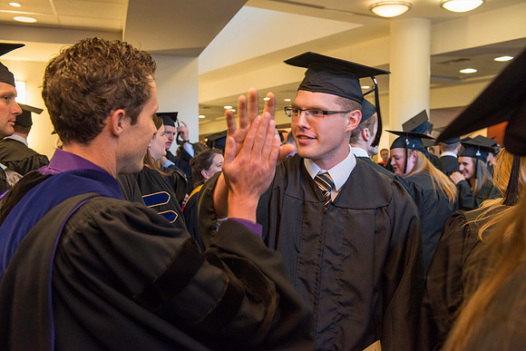 Graduates gather for BYU-Idaho commencement. Graduates march in during the processional.
