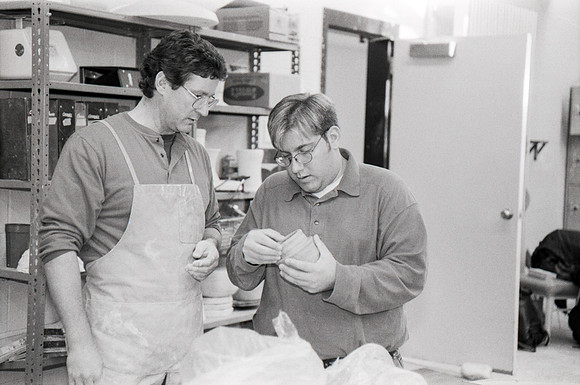 Rich Briggs helps a student as creates his piece of pottery.