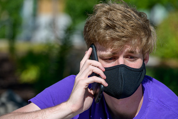 Student volunteers show the way to stay safe during this COVID 19 pandemic by social distancing, following pathway arrows and proper wearing of masks .