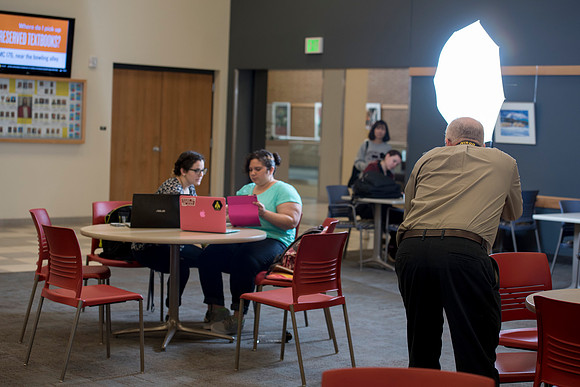Mike Lewis takes a picture of Bethany Nielson and Annie Reyes, as they study together in the MC.