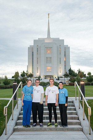 Team members pose by the Rexburg temple before they begin the temple to temple run