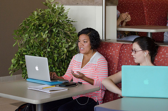 Students on their computers between classes