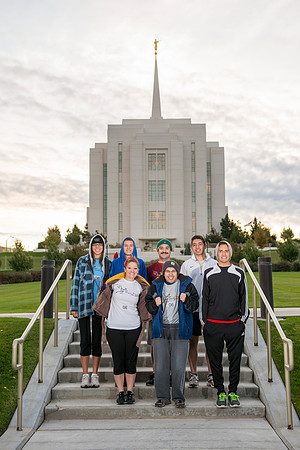 Team members pose by the Rexburg temple before they begin the temple to temple run
