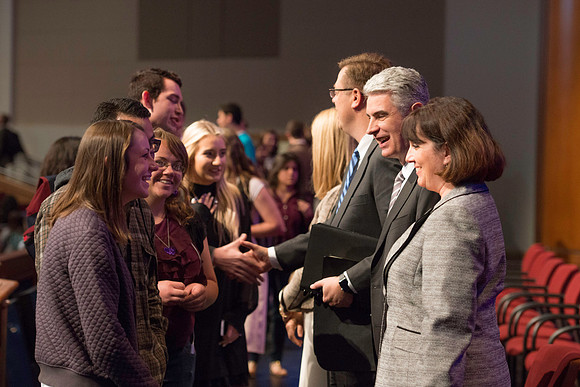 Bishop Gérald Caussé and his wife greet students after devotional.