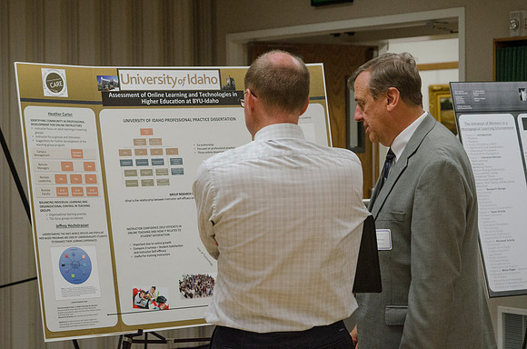 Faculty members talking together at the faculty meeting Fall 2013