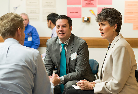 Faculty gather in the Hinckley Building at a Faculty Conference to share and learn from each other at the beginning of the 2013 Fall semester.