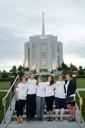 Team members pose by the Rexburg temple before they begin the temple to temple run