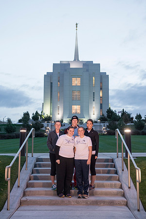 Team members pose by the Rexburg temple before they begin the temple to temple run
