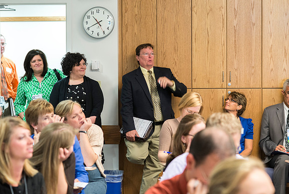 Faculty gather in the Hinckley Building at a Faculty Conference to share and learn from each other at the beginning of the 2013 Fall semester.