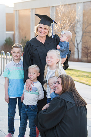 Graduates take a photo together with their family.