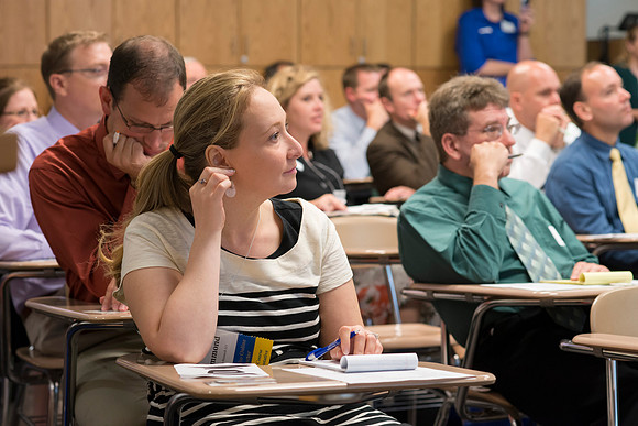 Faculty gather in the Hinckley Building at a Faculty Conference to share and learn from each other at the beginning of the 2013 Fall semester.