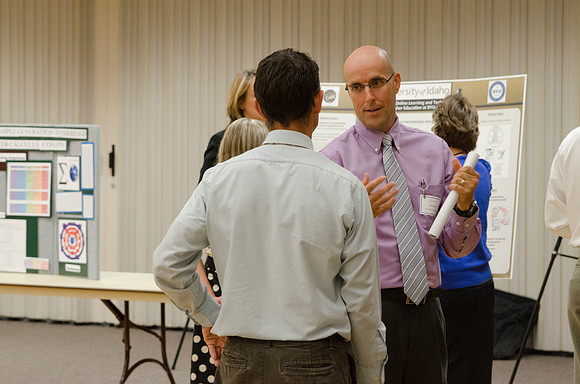 Faculty members talking together at the faculty meeting Fall 2013