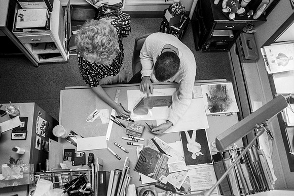 Graphic Design students, Dawn Franson and Gheen Hillman, work on a project together.