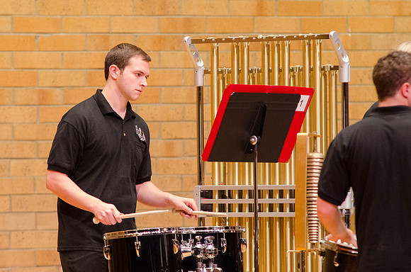 Student playing drums at the RixStix concert, Spring 2013