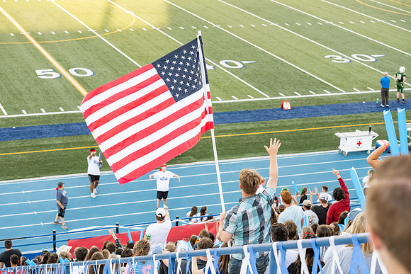 Students gather at the stadium to watch the football championship.