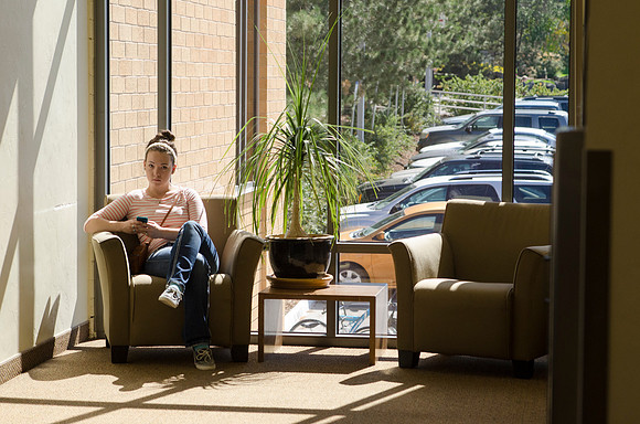 Student texting in the Eliza R Snow Building