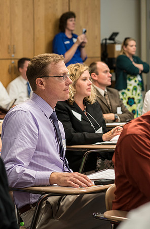 Faculty gather in the Hinckley Building at a Faculty Conference to share and learn from each other at the beginning of the 2013 Fall semester.