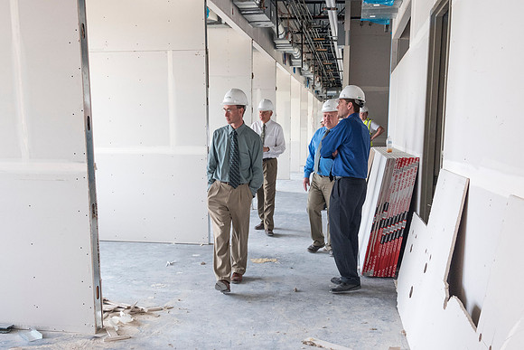 Faculty Members check out the faculty offices in the new science and technology building while it is still under construction.
