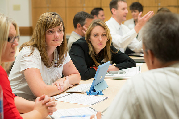 Faculty gather in the Hinckley Building at a Faculty Conference to share and learn from each other at the beginning of the 2013 Fall semester.