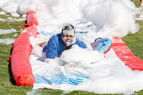 Students gather by the upper fields on the BYU-Idaho Campus to play recreation games, slip 'n' slide, mud volleyball, and try the ropes course.