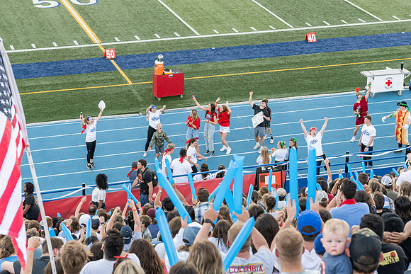 Students gather at the stadium to watch the football championship.