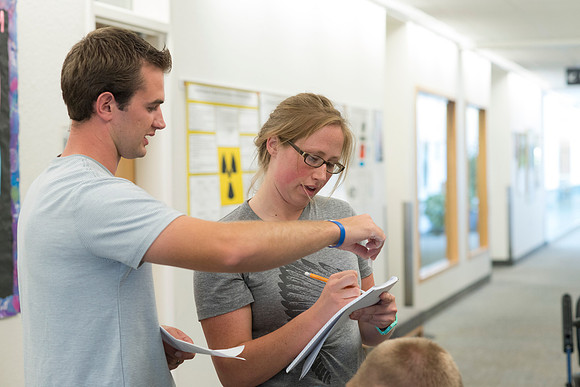 Math students working together on an assignment in the hall of the Ricks Building.