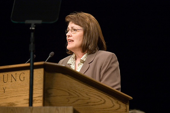 Sister Sue Clark speaking at a devotional.